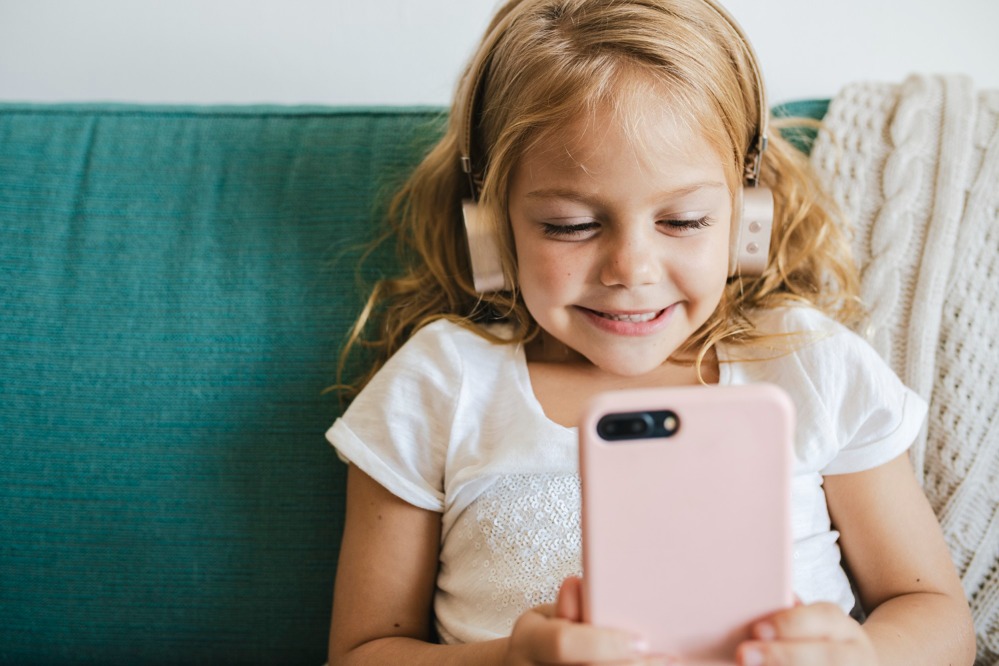 little-girl-watching-cartoons-her-phone.jpg